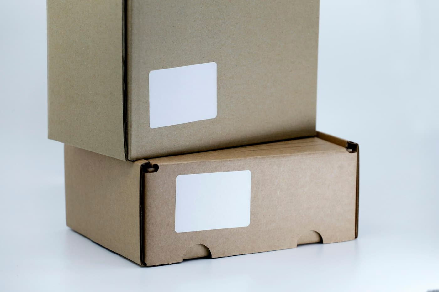 Two cardboard parcels with blank shipping labels
